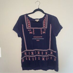 Lucky Brand navy blue embroidered top with red and white accents.